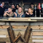 Staff celebrate the opening of a new terrace bar at Wine and Wallop
