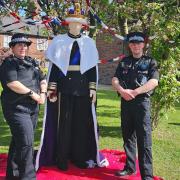 Police officers with a life-sized woollen figure of King Charles