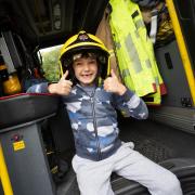A child having a fabulous time in a fire engine