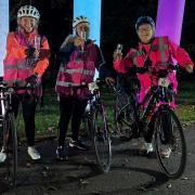 Sarah Vickers celebrates completing the  night ride with cyclists she met along the way