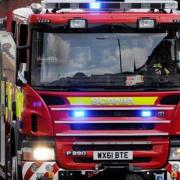 Firefighters rescued a man after a car fell down an embankment into shallow water