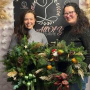 Florists Jess Oliver-Clewes and Sarah Jackson with Christmas wreaths made at another class