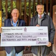 Cllr Jon Newell, chairman of Wilmslow Town Council, presents  £34,651 to Will McKeller, chief officer of Citizens Advice Cheshire North