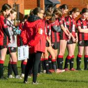 Holmes Chapel Hurricanes under 14s girls football team line up to pay respects to the fallen on Remembrance weekend, ahead of their Cheshire Girls League clash with Winsford Town. Picture: g.mooresportsnaturephotography
