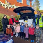 Wilmslow Rotary Club secretary Ian Bradley, right, collects boxes full of toys donated by Pepperberry Day Nursery