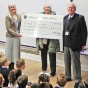 Andrea Booth, head teacher of Handforth Grange Primary School receives a cheque from Cllrs Susan Moore and  Roger Small