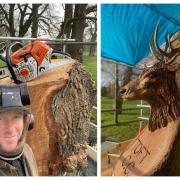 Chainsaw wood sculptor Andy Burgess with the stag's head carving at Toft Cricket Club