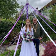 May Queen Orla Bolton with the mayor underneath a maypole in her Knutsford garden