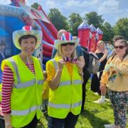 Knutsford Lions Dee Griffiths and Sarah Flannery with children on a bouncy castle at a previous Community Fair