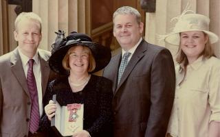 Sandra outside Buckingham Palace after being made a Dame in the New Year Honours in 2004, with her family, from left, Matthew, Eliot and Victoria